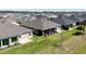 An aerial view of single-Gathering homes showcases their tidy lawns and proximity to each other in a quiet community at 3334 Pierluissi Path, The Villages, FL 32163