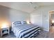 Well-lit bedroom featuring plank flooring and neutral decor at 3334 Pierluissi Path, The Villages, FL 32163