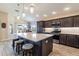 Modern kitchen with large island, stainless steel appliances, and stylish pendant lighting at 3334 Pierluissi Path, The Villages, FL 32163