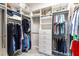 Walk-in closet with built-in shelves, drawers, and hanging storage at 3334 Pierluissi Path, The Villages, FL 32163