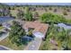 Aerial view of single Gathering home with mature trees and greenery surrounding the property at 337 Olanta Dr, The Villages, FL 32162