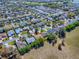 Scenic aerial view of a residential area, featuring numerous homes with varied roof colors and lush greenery at 337 Olanta Dr, The Villages, FL 32162