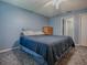 Serene bedroom showcasing blue walls, soft carpeting, and a serene atmosphere at 337 Olanta Dr, The Villages, FL 32162