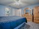 Bright bedroom featuring ample storage with a dresser and access to the bathroom at 337 Olanta Dr, The Villages, FL 32162