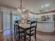 Inviting dining area with wood floors, table for four, and sliding glass door to the outside at 337 Olanta Dr, The Villages, FL 32162