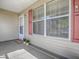 Inviting covered front porch with a tidy entrance, featuring potted plants and fresh curb appeal at 337 Olanta Dr, The Villages, FL 32162