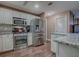 Modern kitchen featuring stainless steel appliances and ample counter space with white cabinetry at 337 Olanta Dr, The Villages, FL 32162