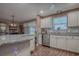 Well-lit kitchen featuring stainless steel appliances, granite counters, and eat-in dining space at 337 Olanta Dr, The Villages, FL 32162