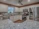 Bright kitchen with stainless steel appliances, granite countertops, and updated cabinetry at 337 Olanta Dr, The Villages, FL 32162