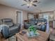 Bright living room with hardwood floors, comfortable seating, and a clear view into the dining area at 337 Olanta Dr, The Villages, FL 32162