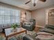 Cozy living room with hardwood floors, a ceiling fan, and comfortable seating near a window at 337 Olanta Dr, The Villages, FL 32162