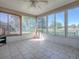 Bright sunroom with tile flooring and large windows providing natural light and views of the outdoors at 337 Olanta Dr, The Villages, FL 32162