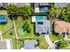 Aerial view showcasing the home's roof, solar panels, and a well-maintained lawn with a basketball court at 342 Lake Amberleigh Dr, Winter Garden, FL 34787