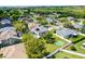 Aerial view of the property featuring a large yard with basketball court, mature trees, and neighborhood at 342 Lake Amberleigh Dr, Winter Garden, FL 34787