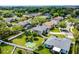 Aerial view of the home with a basketball court in the yard, showcasing the community and nearby greenery at 342 Lake Amberleigh Dr, Winter Garden, FL 34787