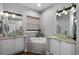 Bright bathroom featuring dual vanities, a soaking tub, and luxurious countertops at 342 Lake Amberleigh Dr, Winter Garden, FL 34787