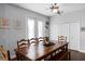 Bright dining room features a wooden table, bench seating and double doors to a covered patio at 342 Lake Amberleigh Dr, Winter Garden, FL 34787