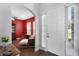 Bright foyer with a white front door and an arched entrance leading to a living room with red walls at 342 Lake Amberleigh Dr, Winter Garden, FL 34787