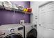 Well-organized laundry room with modern appliances and overhead shelving for convenient storage solutions at 342 Lake Amberleigh Dr, Winter Garden, FL 34787