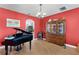 Living room featuring a grand piano, china cabinet, and an open archway to the kitchen at 342 Lake Amberleigh Dr, Winter Garden, FL 34787