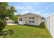 Fenced backyard features a grassy lawn and brick patio at 3646 Maidencain St, Clermont, FL 34714