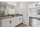 Bathroom with double vanity and views into adjacent bedroom at 3646 Maidencain St, Clermont, FL 34714