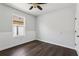 Bright bedroom features dark wood-look floors, and a ceiling fan at 3646 Maidencain St, Clermont, FL 34714