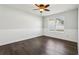 Bedroom with ceiling fan, dark wood-look floors, and natural light at 3646 Maidencain St, Clermont, FL 34714