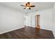 Bedroom features ceiling fan, dark wood-look floors, and two doorways at 3646 Maidencain St, Clermont, FL 34714