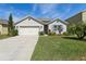 Charming single-story home featuring an attached two-car garage and beautifully landscaped front yard at 3646 Maidencain St, Clermont, FL 34714