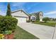 Well-manicured lawn, attached garage, and an inviting exterior provide this house with curb appeal at 3646 Maidencain St, Clermont, FL 34714