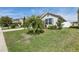 The front yard has a well-maintained lawn, with a palm tree and various bushes enhancing its appeal at 3646 Maidencain St, Clermont, FL 34714