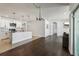 Bright and open kitchen with pendant lighting, stainless appliances, and a view into the living room at 3646 Maidencain St, Clermont, FL 34714