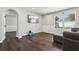 Cozy living room with modern flooring, wainscotting, and a large window for lots of natural light at 3646 Maidencain St, Clermont, FL 34714