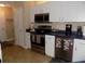 Well-lit kitchen featuring white cabinetry, stainless steel appliances, and contrasting countertops at 36709 Sandy Ln, Grand Island, FL 32735