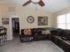 Comfortable living room with a large leather sectional sofa and neutral color scheme at 36709 Sandy Ln, Grand Island, FL 32735