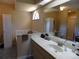 Well-lit bathroom with a large mirror, vanity with storage, and a separate shower area at 36709 Sandy Ln, Grand Island, FL 32735