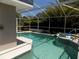 Beautiful private screened-in pool with a spa and mature landscaping at 36709 Sandy Ln, Grand Island, FL 32735