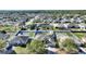 Aerial view of a home with a screened-in pool and fenced backyard in a residential neighborhood at 410 Majestic Gardens Blvd, Winter Haven, FL 33880