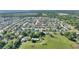 An aerial view of a neighborhood with lush greenery and well-maintained homes at 410 Majestic Gardens Blvd, Winter Haven, FL 33880