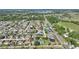 An aerial view shows a tranquil residential neighborhood close to a lake and fields at 410 Majestic Gardens Blvd, Winter Haven, FL 33880