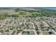 An aerial view featuring a neighborhood near vast fields and a tree line at 410 Majestic Gardens Blvd, Winter Haven, FL 33880