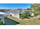 Landscaped backyard view showcasing the home's exterior and well-manicured lawn at 410 Majestic Gardens Blvd, Winter Haven, FL 33880