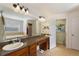 Bathroom with double vanity, granite countertop, soaking tub, and walk-in shower at 410 Majestic Gardens Blvd, Winter Haven, FL 33880