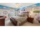 Bedroom featuring a unique, hand-painted mural and a comfortable queen-sized bed at 410 Majestic Gardens Blvd, Winter Haven, FL 33880