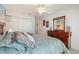 A well lit, clean bedroom featuring neutral colored walls and a comfortable bed with plush pillows at 410 Majestic Gardens Blvd, Winter Haven, FL 33880