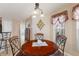 Cozy breakfast nook with a round table, chandelier, and elegant window treatments at 410 Majestic Gardens Blvd, Winter Haven, FL 33880