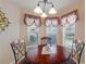 Bright breakfast nook with a charming chandelier and a view of the pool at 410 Majestic Gardens Blvd, Winter Haven, FL 33880