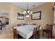 Formal dining room features a chandelier, large table with seating for six at 410 Majestic Gardens Blvd, Winter Haven, FL 33880