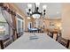 Formal dining area with a chandelier, adjacent to the living area at 410 Majestic Gardens Blvd, Winter Haven, FL 33880